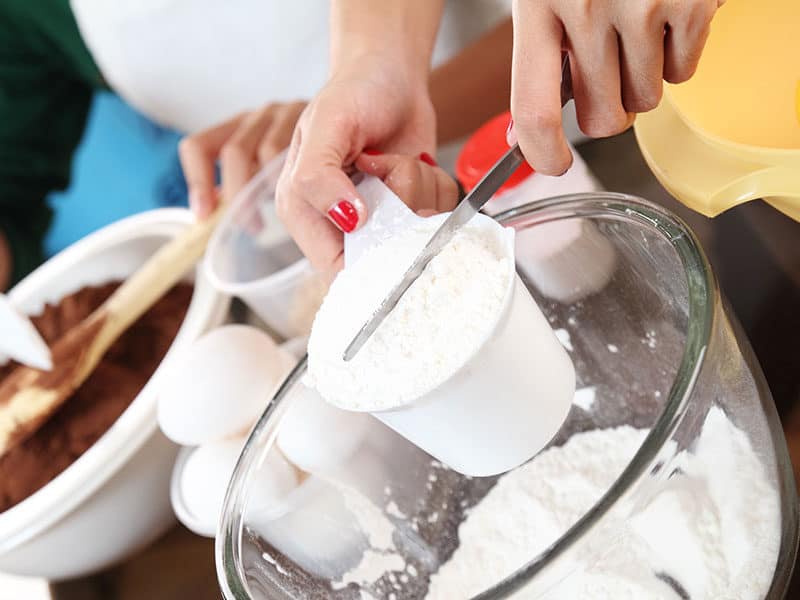 Hands Measuring Flour